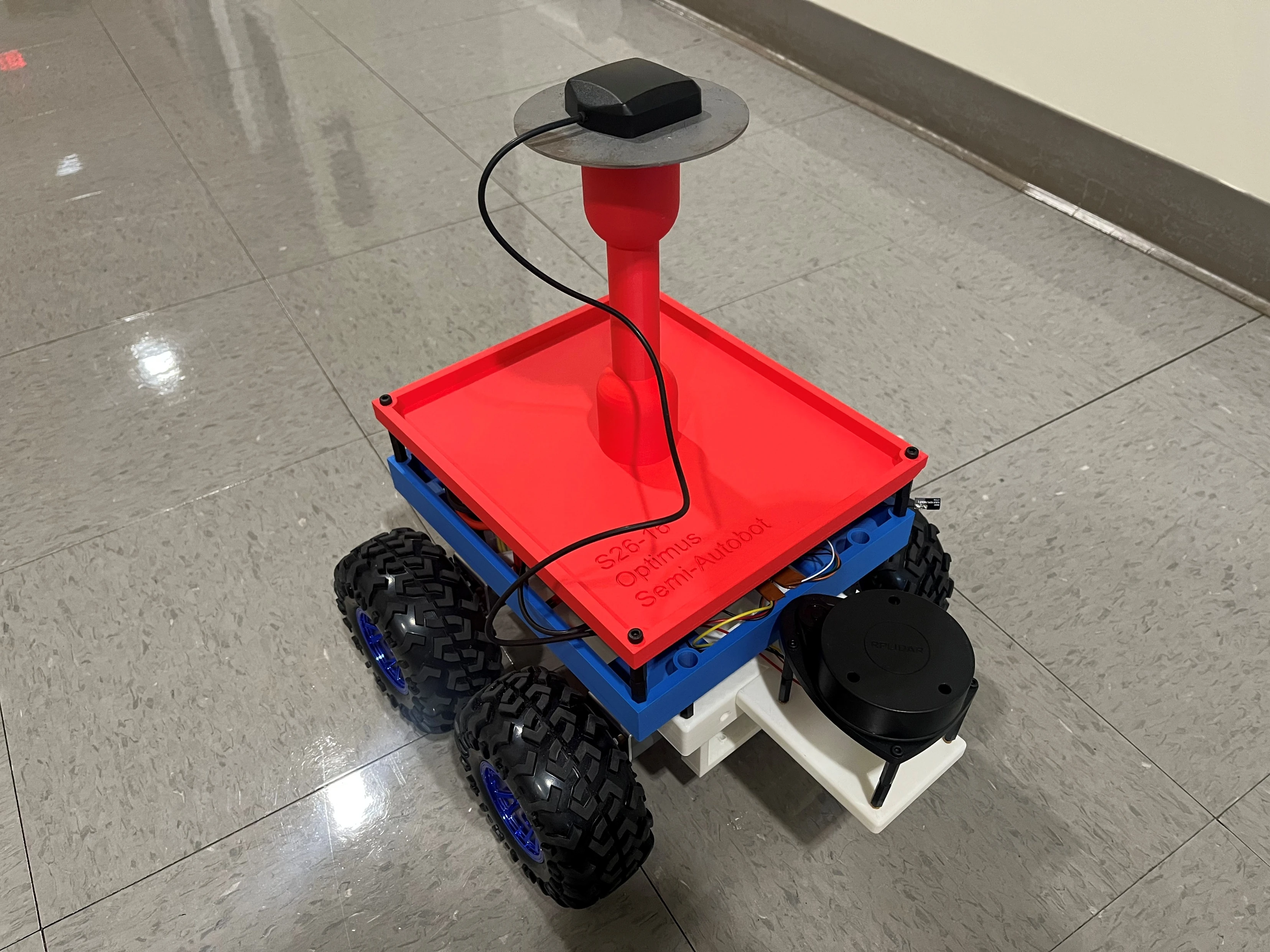Completed Optimus Semi-Autobot with a red upper platform, blue chassis, four wheels, elevated GPS sensor, and front-mounted RPLIDAR.